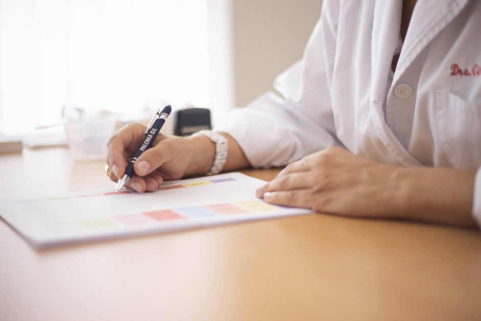Doctor writing an oxycodone prescription for a patient during a consultation