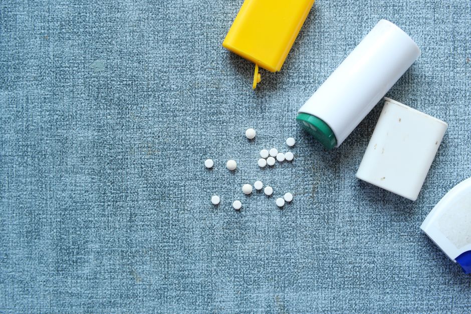 Ibuprofen tablets next to an oxycodone prescription bottle representing drug interaction safety