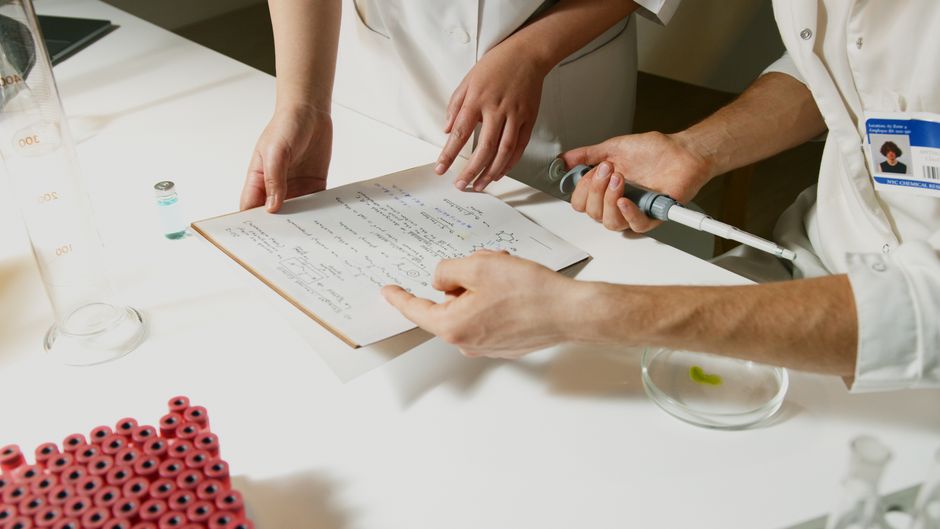 Laboratory technician examining a urine drug test sample for oxycodone detection