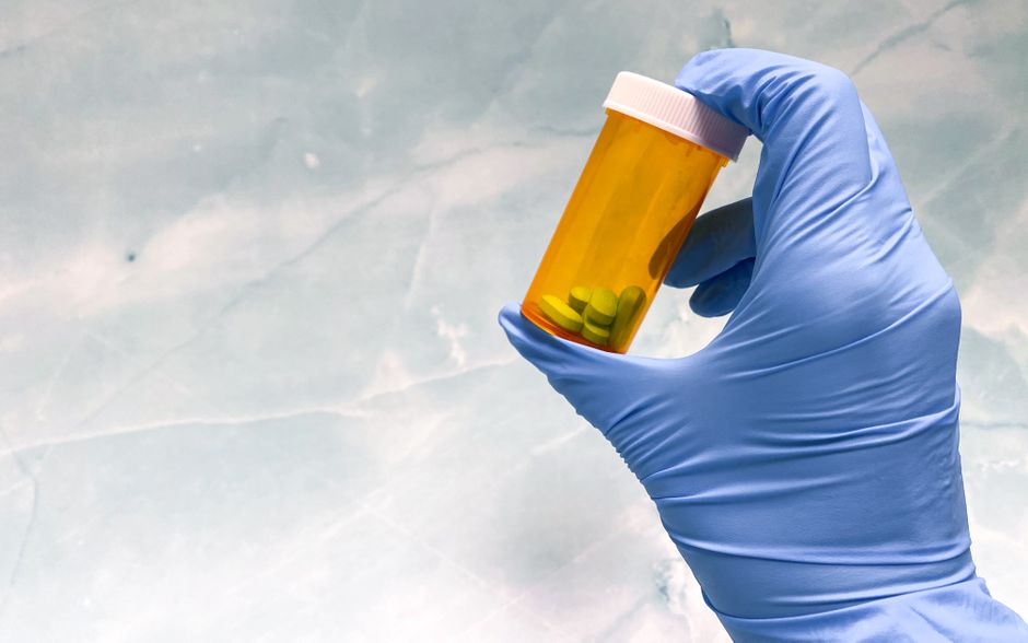 Oxycodone prescription bottle with pills on a table, representing oxycodone information for Texas patients