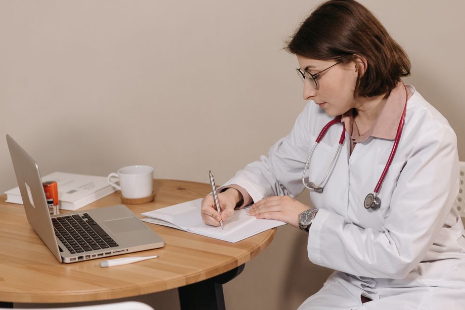 Primary care doctor discussing an oxycodone prescription with a patient in an exam room