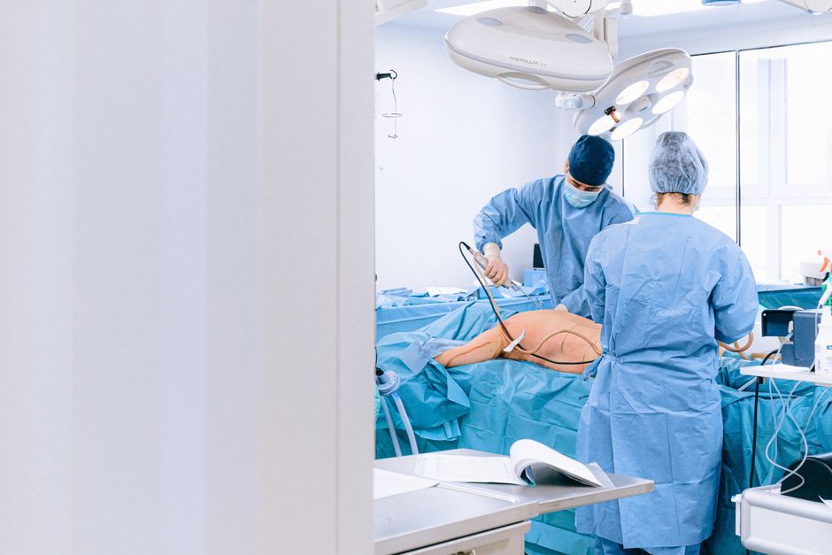 Surgical team preparing a patient for surgery while discussing oxycodone medication history