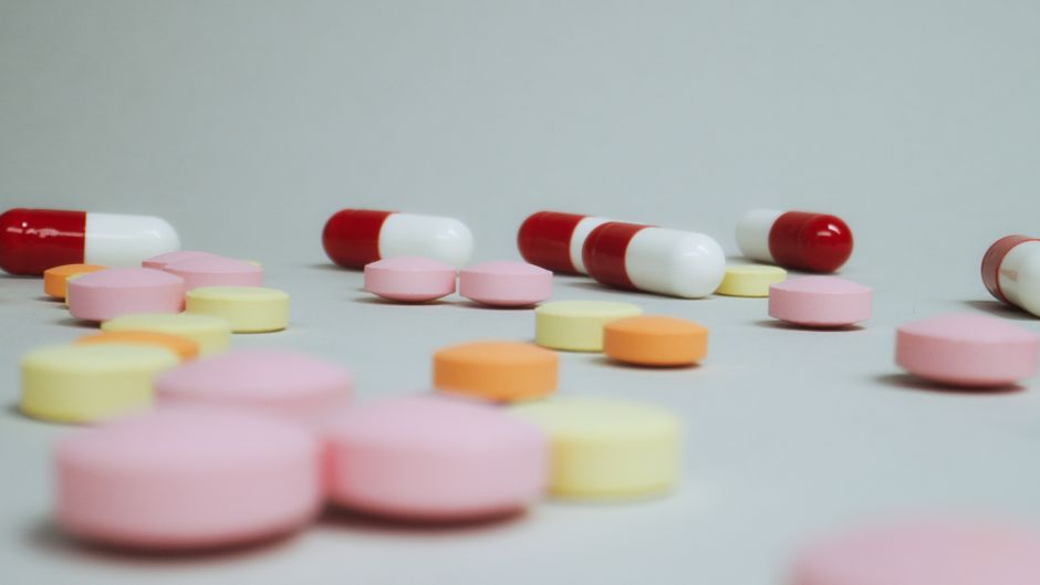 Traveler placing prescription oxycodone bottle into carry-on bag at airport security