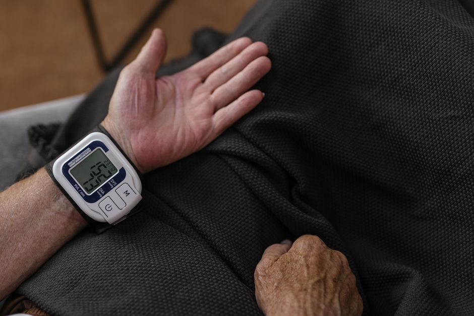 Person checking blood pressure reading while taking oxycodone medication