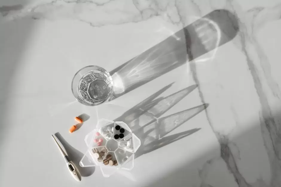 A cup of coffee next to oxycodone pills on a table, representing the interaction between caffeine and opioid medication