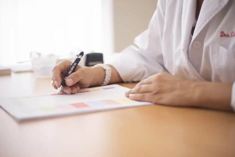 Doctor writing an oxycodone prescription for a patient during a consultation