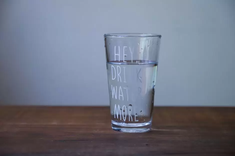 Person drinking a glass of water to stay hydrated while wondering if it helps clear oxycodone from the body