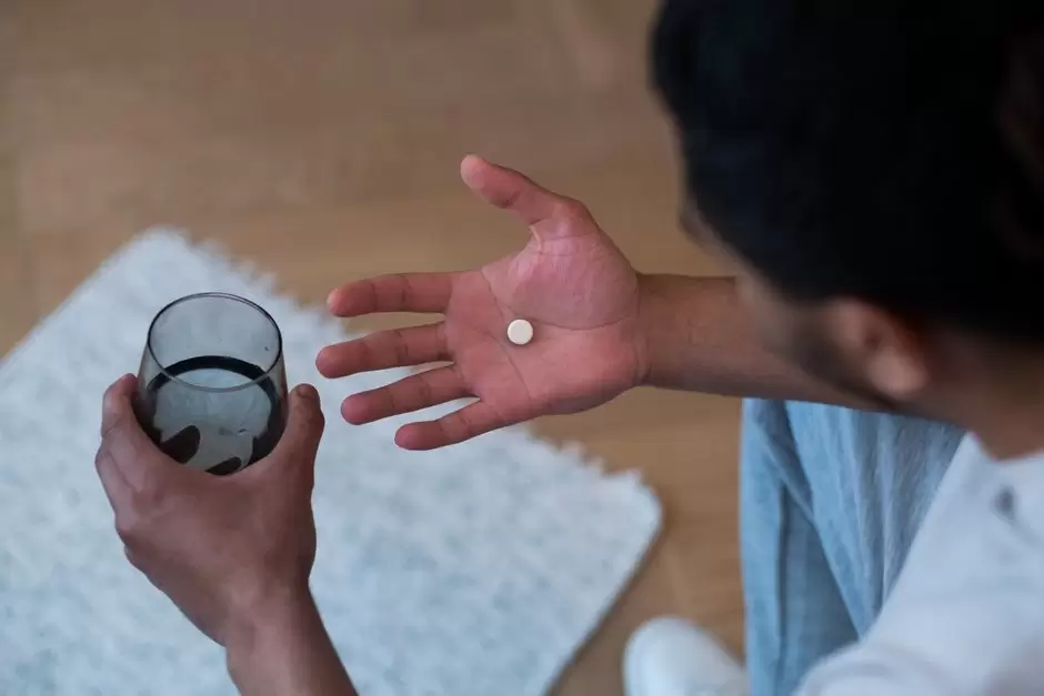 Person holding oxycodone pill bottle near car keys, illustrating driving safety concerns after taking oxycodone