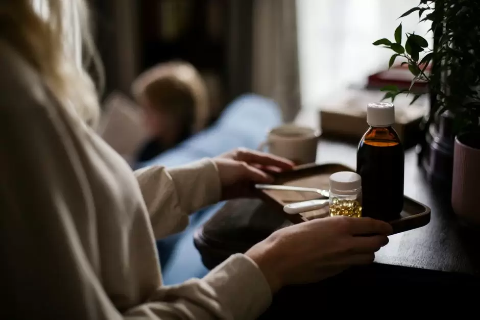 Person sleeping in bed with a pill bottle on the nightstand representing oxycodone drowsiness effects
