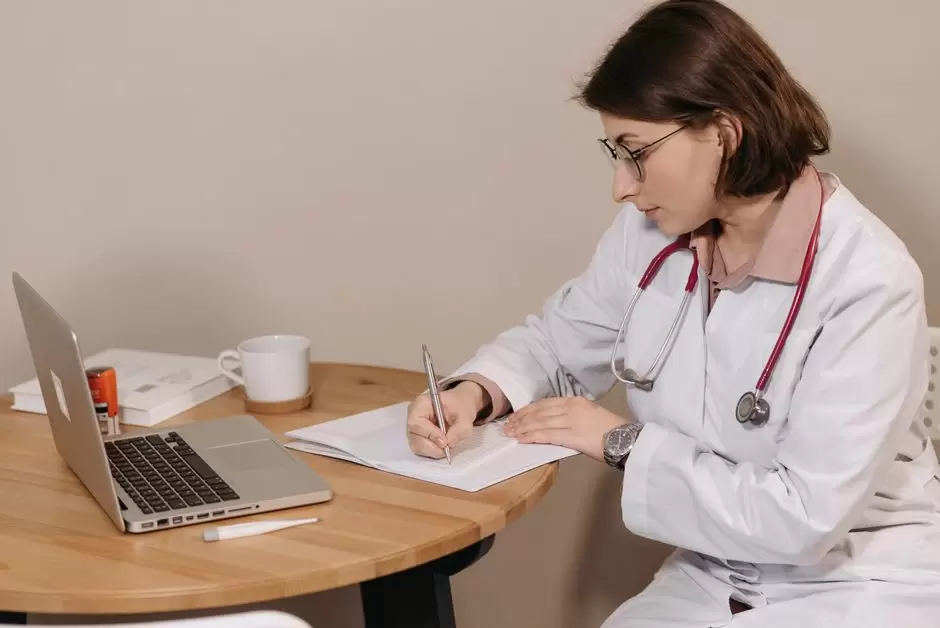 Primary care doctor discussing an oxycodone prescription with a patient in an exam room