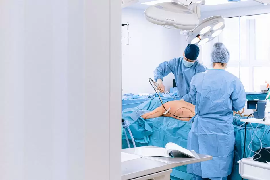 Surgical team preparing a patient for surgery while discussing oxycodone medication history