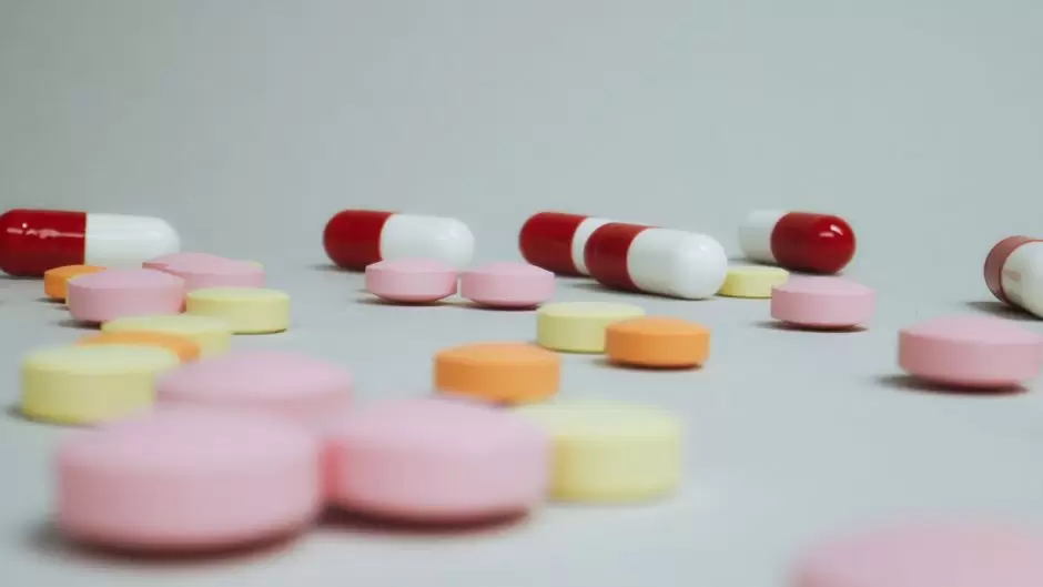Traveler placing prescription oxycodone bottle into carry-on bag at airport security