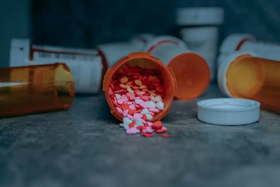 Different strengths of oxycodone tablets spilled next to a prescription bottle